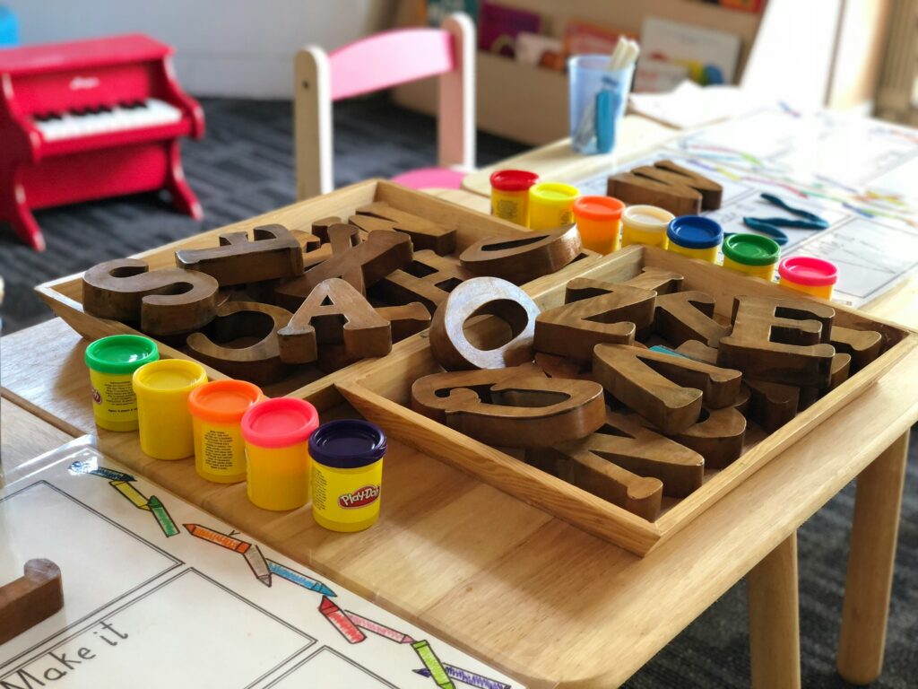 Chair and table with letter blocks on the table.